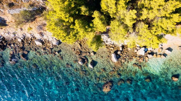 The stunning beauty of Croatia's rocks and forests is captured in this breathtaking aerial view. Take in the turquoise waters and beach from above, and add this travel image to your collection of unforgettable memories.