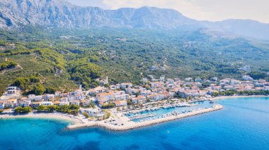 Hırvatistan 'ın büyüleyici kıyı kenti Makarska' ya yeni bir perspektiften bakın. Güneşli bir günde bu muhteşem insansız hava aracı çekim panoramasıyla..