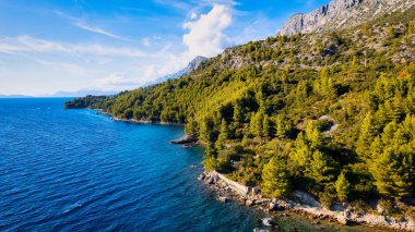 Marvel at the stunning aerial perspective of Croatia's Makarska Riviera, displaying a rocky beach and the captivating turquoise water.