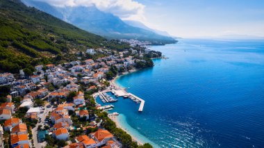 Take in the beauty of Croatia's coastal region from a new perspective with this stunning drone view, which features clear blue water and forested land.