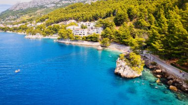 Marvel at the stunning aerial perspective of Croatia's Makarska Riviera, displaying a rocky beach and the captivating turquoise water.