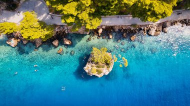 Marvel at the stunning aerial perspective of Croatia's Makarska Riviera, displaying a rocky beach and the captivating turquoise water.