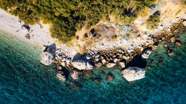 stock image Marvel at the stunning aerial perspective of Croatia's Makarska Riviera, displaying a rocky beach and the captivating turquoise water.