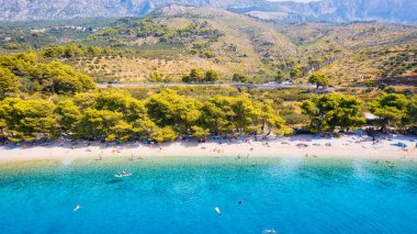 Marvel at the stunning aerial perspective of Croatia's Makarska Riviera, displaying a rocky beach and the captivating turquoise water.