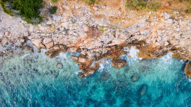 Adriyatik Denizi 'nin ve Pzekeni adaları ve kristal berrak turkuaz sularının uzaktan takdir edilebileceği engebeli bir Hırvat kayalık yamacının buluşmasına tanık olun..