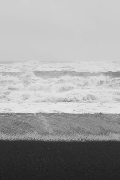 Ocean water swirling at storm monochrome landscape photo. Beautiful nature scenery photography with sky on background. Idyllic scene. High quality picture for wallpaper, travel blog, magazine, article