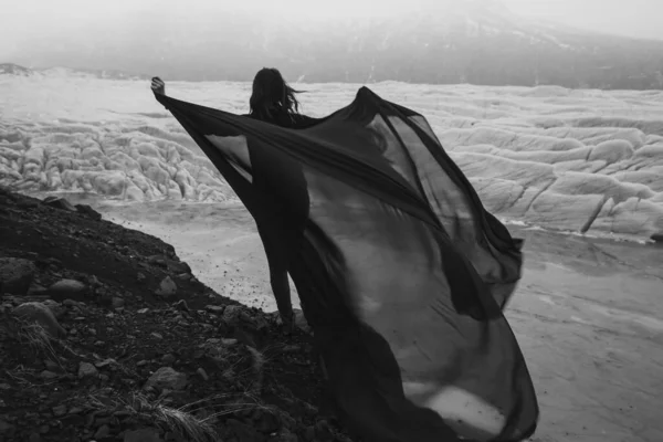 布のシートを振って優雅な女性モノクロの風光明媚な写真 背景に氷河の高い人の写真 高品質の壁紙 旅行ブログ 記事のための写真のコンセプト — ストック写真