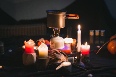 Close up cozy camp kitchen concept photo. Burning candles. Camping cooking gear. Front view photography with blurred background. High quality picture for wallpaper, travel blog, magazine, article