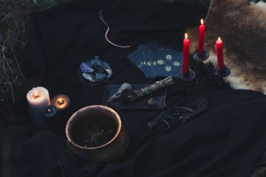 Close up witchcraft tools for magic concept photo. Dark witchcore aesthetic. Front view photography with blurred background. High quality picture for wallpaper, travel blog, magazine, article