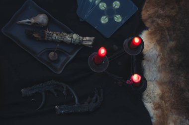 Close up divination on candles concept photo. Fortune telling. Witchcore aesthetic. Top view photography with blurred background. High quality picture for wallpaper, travel blog, magazine, article