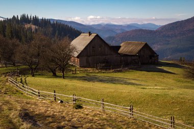 Abandoned house in Carpathian mountains landscape photo. Nature scenery photography with forest on background. Ambient light. High quality picture for wallpaper, travel blog, magazine, article