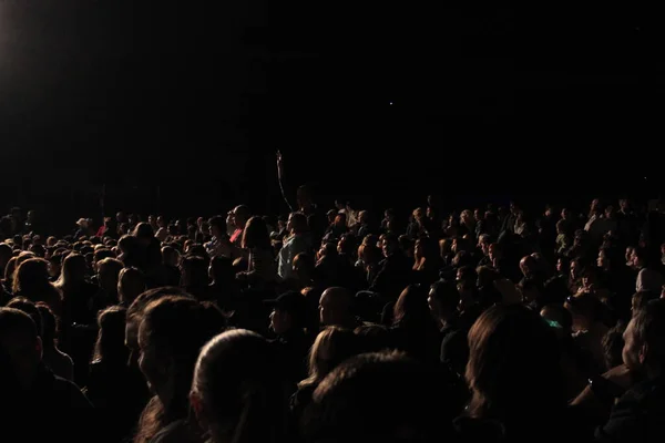 stock image a crowd of people sitting in the dark waiting for the performance to begin