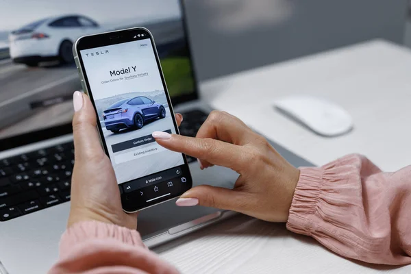 stock image CALIFORNIA, USA - NOVEMBER 14, 2022: Ordering full self-driving autopilot for Tesla model Y. Smartphone shopping for a Tesla car browsing preferences with the intent to purchase the vehicle online.