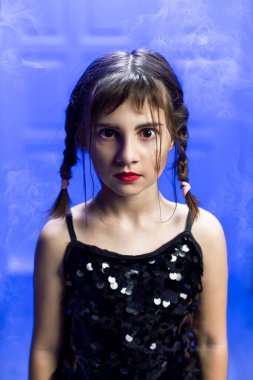 Portrait of teenage girl content on social media. Young blogger shoots TikTok youtube content on the phone. Fantasy gothic black-haired girl witch