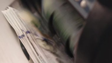 Quick credit from cash. Currency counting machine counting dollar banknotes. Automatic equipment for counting paper money. Close up of cash money counting equipment. Banking and commercial activity.