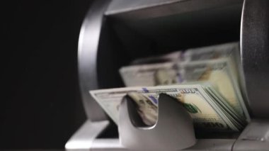 Closeup of cash counting machine counting dollar bills. Business accounting and commercial activity, american monetary units. Counting machine with US national cash money.