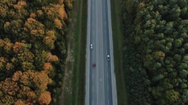 Aerial shot expensive luxury sport electric car SUV driving on the sunny road highway to mountains. Joy future packshot. White car travels in beautiful asphalt road with a beautiful landscape.