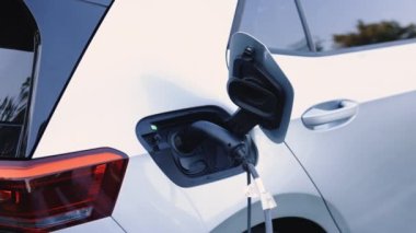 Elektrik güç dolumu yarışması ve kablo bağlantısı koptu. Tanınmayan işadamı elektrikli arabanın fişini çekiyor. Lüks elektrikli araba dolu. Ekoloji alternatif enerjisini gelecek sürdürülebilir olarak kaydet.