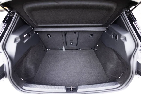 Rear view of the car open trunk. Modern hatchback car with open empty trunk. The car boot is open for luggage. A lot of space for coffers and bags. Ready for a trip