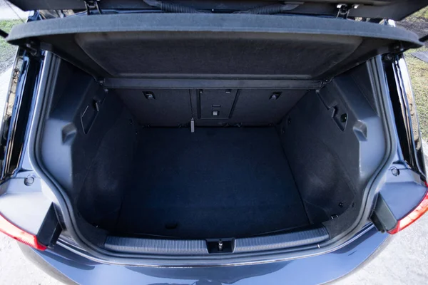 Rear view of the car open trunk. Modern hatchback car with open empty trunk. The car boot is open for luggage. A lot of space for coffers and bags. Ready for a trip