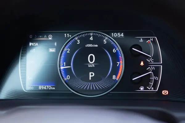 Dashboard of a modern expensive car. The interior of the car. Modern luxury hybrid car interior details. Speedometer and tachometer with additional instruments on car dashboard.