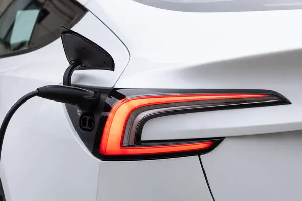 Electric car charging. Electric vehicle charging port plugging in car. Charging technology, Clean energy filling technology.