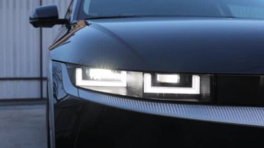 Modern car headlamp flashing light with blinking on continuously indicator. Car Front Full Led Light. Switched on led lights of luxury car. Car Blinker Light.