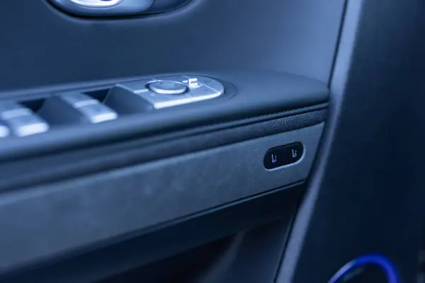 Control buttons for settings and memory of the drivers seat, electric glass opening, door handle in the interior of the new luxury electric car. Drivers seat adjustment buttons.