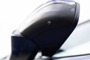 Modern arabadaki çevre kamerası sistemi. Kamera lensi yan ayna kör nokta kamera sisteminin altında. Park destek sistemleri. 360 Derece Çevre Görünümü Ters Kamera Ön Kamera.