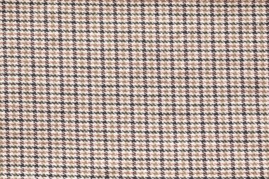 Klasik bir houndstooth desenli örülmüş kumaş, sessiz ve sıcak renkler sergiliyor..