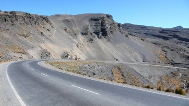 Issız yol dağları mavi gökyüzü kıvrımlarını geçer. Yüksek kalite fotoğraf