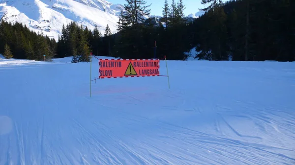 Slow down sign La Clusaz France Ski Blue Ski Piste Holiday Alps. High quality photo