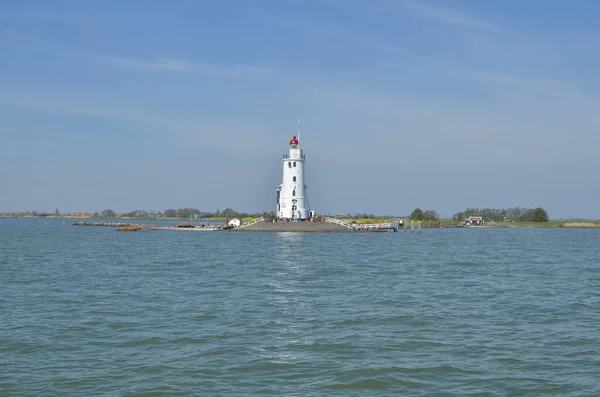 Stock image lighthouse in netherlands at seablue sky water. High quality photo