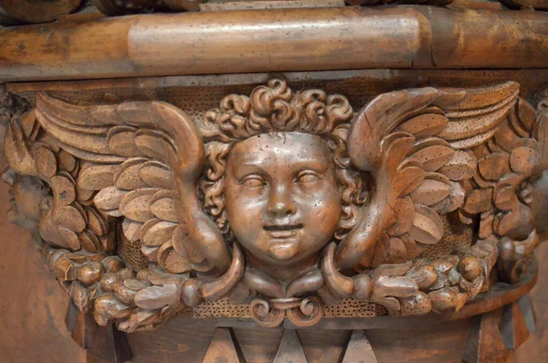 wood carved Angel face with wings in old Altar. High quality photo