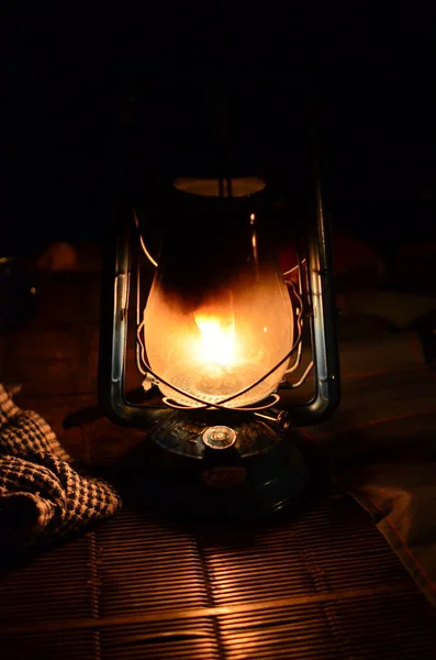 Old kerosene oil petrolium lantern with warm yellow light . High quality photo
