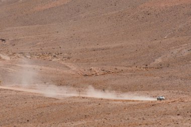 Dusty road with car from distance chile. High quality photo