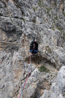 man hanging on rope dolomites panoramic views climbing outdoor europe. High quality photo