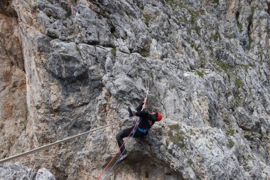 man hanging on rope dolomites panoramic views climbing outdoor europe. High quality photo