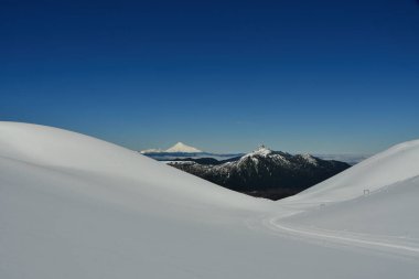 calbuco vulcano Chile winter snow caped panorama ski mountain blue sky. High quality photo clipart