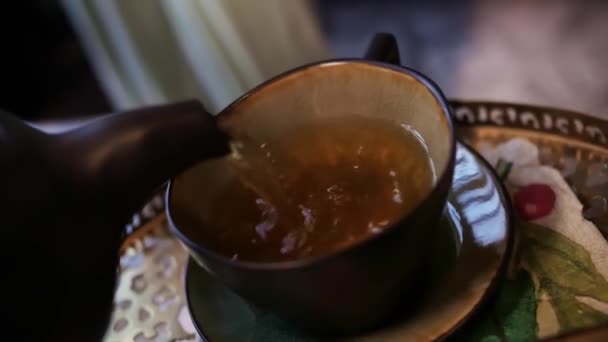 Seorang Gadis Menuangkan Teh Dalam Cangkir Dari Seorang Teapot Woman — Stok Video