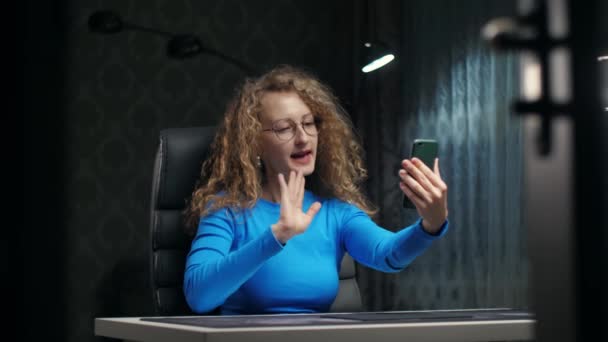 Young Curly Woman Make Video Call Using Phone Sitting Chair — Vídeo de Stock