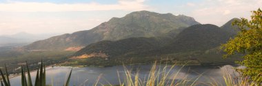 Beautiful mountains with clear sky and a lake captured during a visit to Kodaikanal, Tamil Nadu clipart