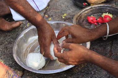 Pitru pinda preparation with riceball during first year death anniversary clipart