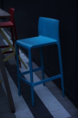 Blue wooden bar stool in the cafe garden outside