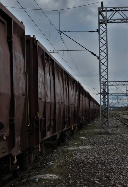 A view of a railroad car, blue cloudy sky