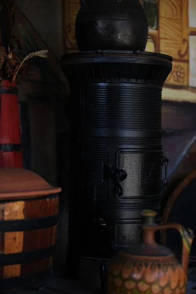 stock image An old black metal wood-burning stove stands in an antique store