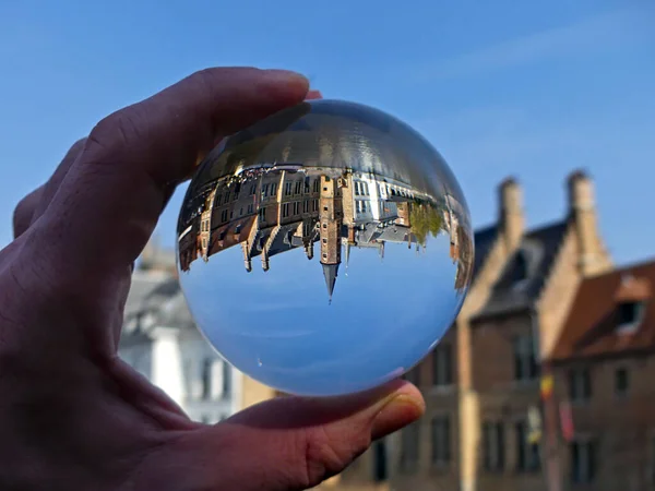 stock image Bruges, April 2023: Magnificents facades of the buildings of Bruges, the Venice of the North through a lensball