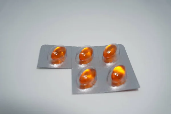 close view of a group of pills on a white background. vitamin c