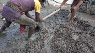 Manually mixing Cement, Sand and broken bricks collection set.