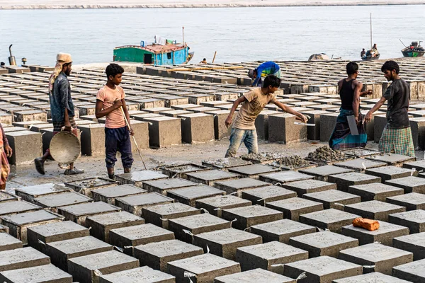 Gaibandha, Babgladeş-23 Ocak 2022-El yapımı çimento, su, ezilmiş taş ve karıştırma makineleri gibi malzemelerle nehri korumak için beton kaya blokları oluşturuldu..